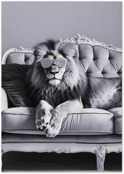 Black and white photo of a lion wearing sunglasses lounging on an ornate tufted sofa