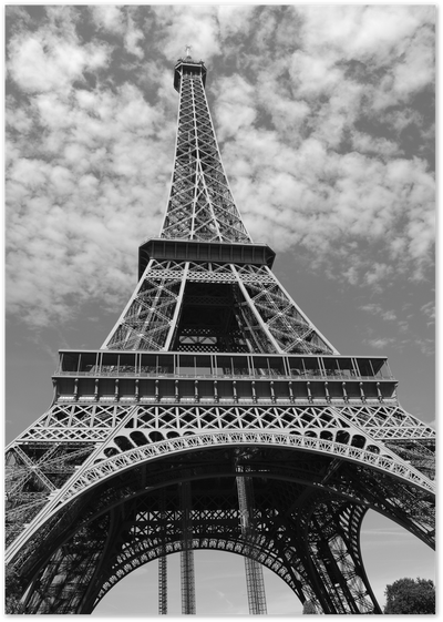 Black and white low-angle photograph of the Eiffel Tower against a cloudy sky