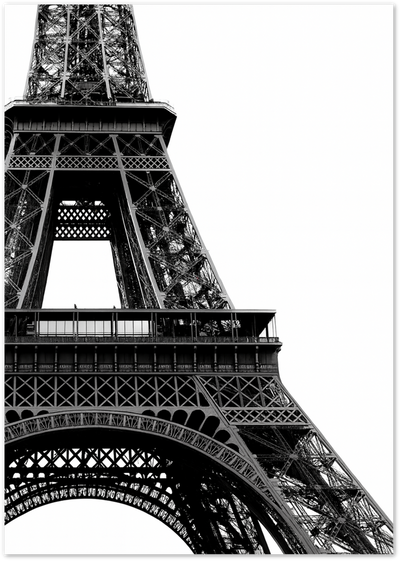 Black and white low-angle photograph of the Eiffel Tower iron structure in Paris