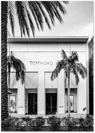 Black and white photo of Tom Ford store facade flanked by palm trees